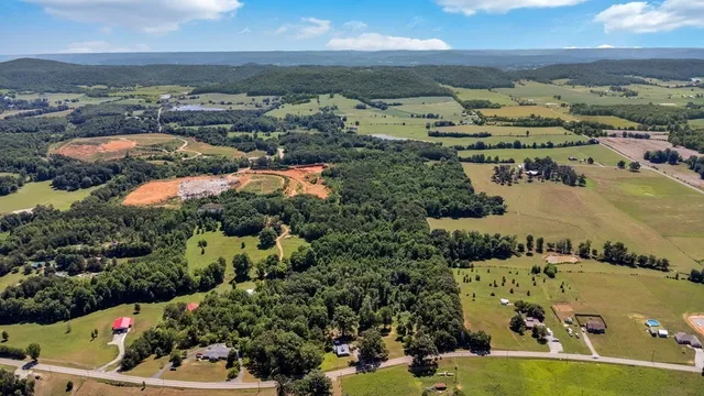 an aerial view of lake and residential houses with outdoor space