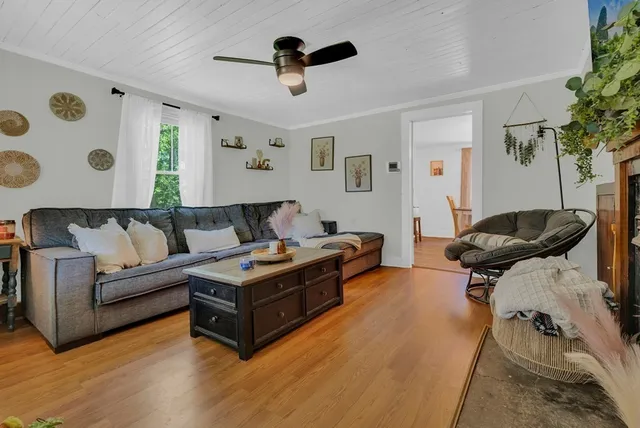 a living room with furniture and wooden floor