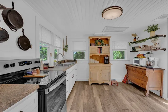 a kitchen with stove and cabinets
