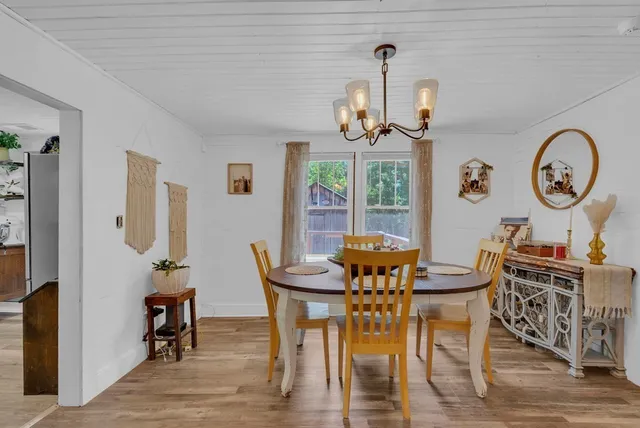 a view of a dining room with furniture wooden floor and a chandelier