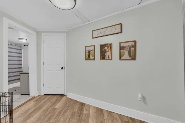 a view of a room with wooden floor and window