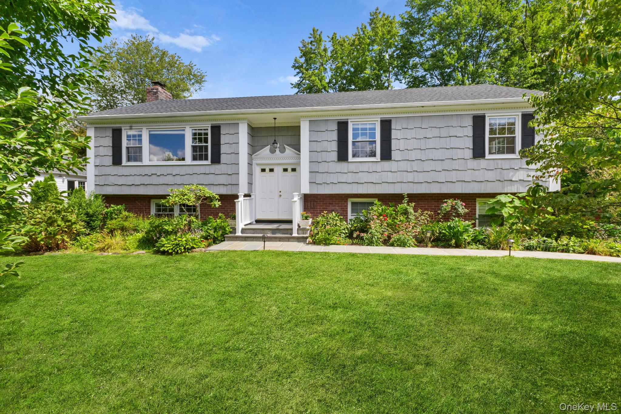 a front view of a house with a yard and porch