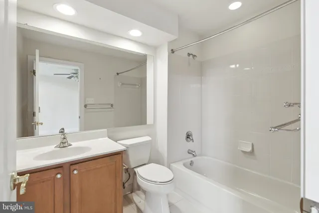 a bathroom with a sink toilet tub and shower