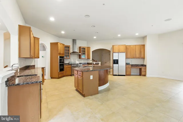 a kitchen with stainless steel appliances granite countertop a stove and a sink