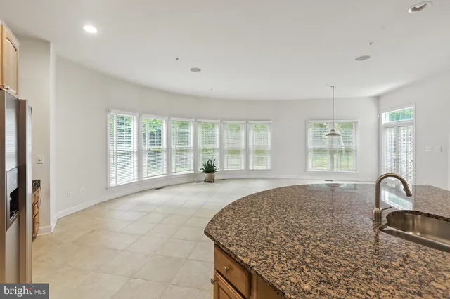 an empty room with a fireplace and a window