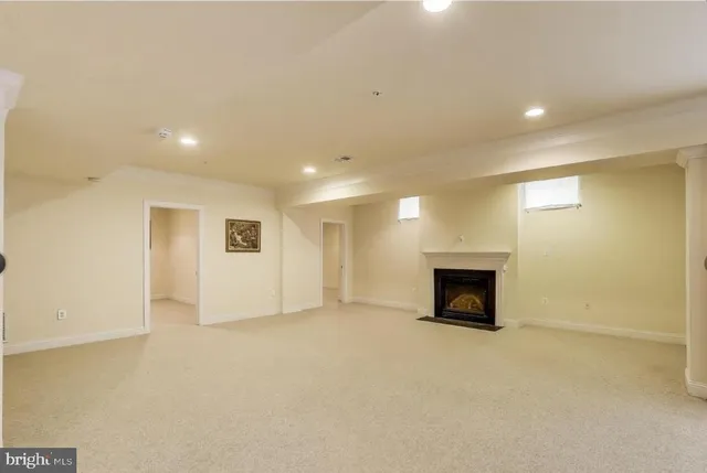 a view of empty room with kitchen