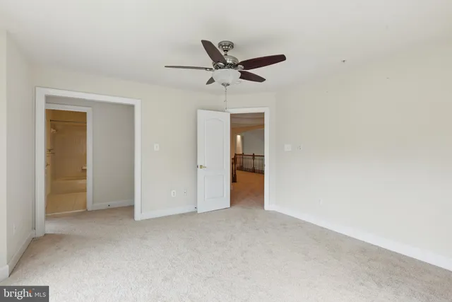 an empty room with closet and windows