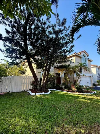 a view of a backyard with tree