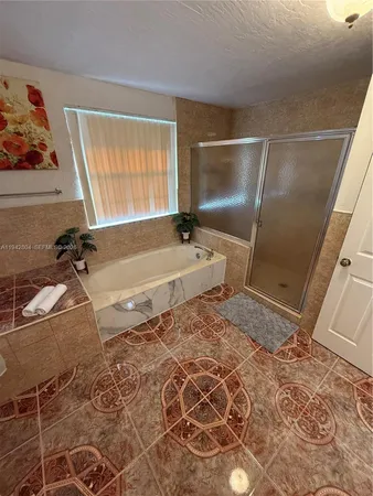 a view of a hallway with wooden floor and furniture