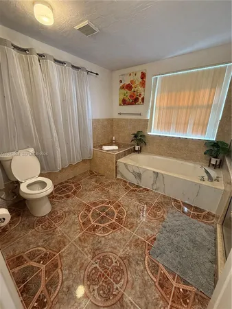 a room with a bed and wooden floor