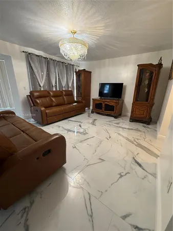 a kitchen with stainless steel appliances kitchen island granite countertop a stove refrigerator and cabinets