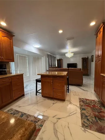 a kitchen with stainless steel appliances granite countertop a stove top oven a sink dishwasher and cabinets with wooden floor