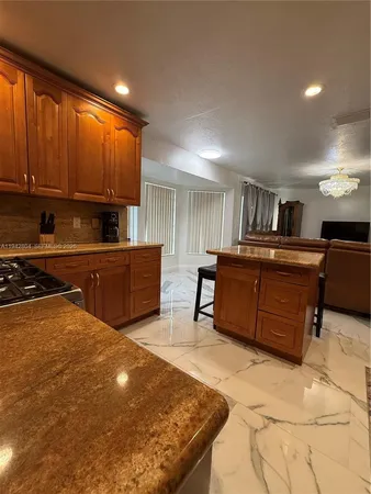 a kitchen with stainless steel appliances a stove a refrigerator and a sink