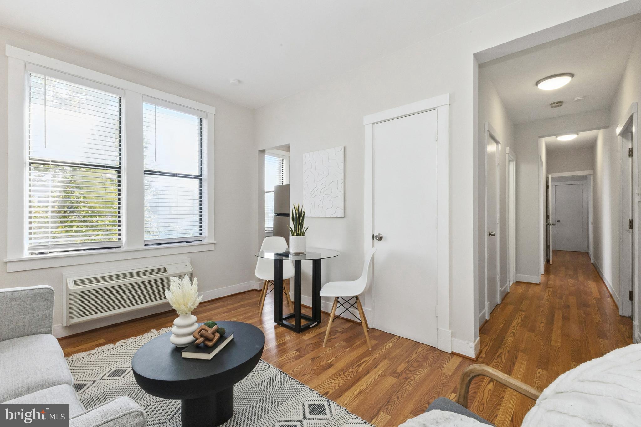 7 18th Street Southeast, Unit 208 Washington, DC 20003 - Photo 4 of 31 a living room with furniture and a window