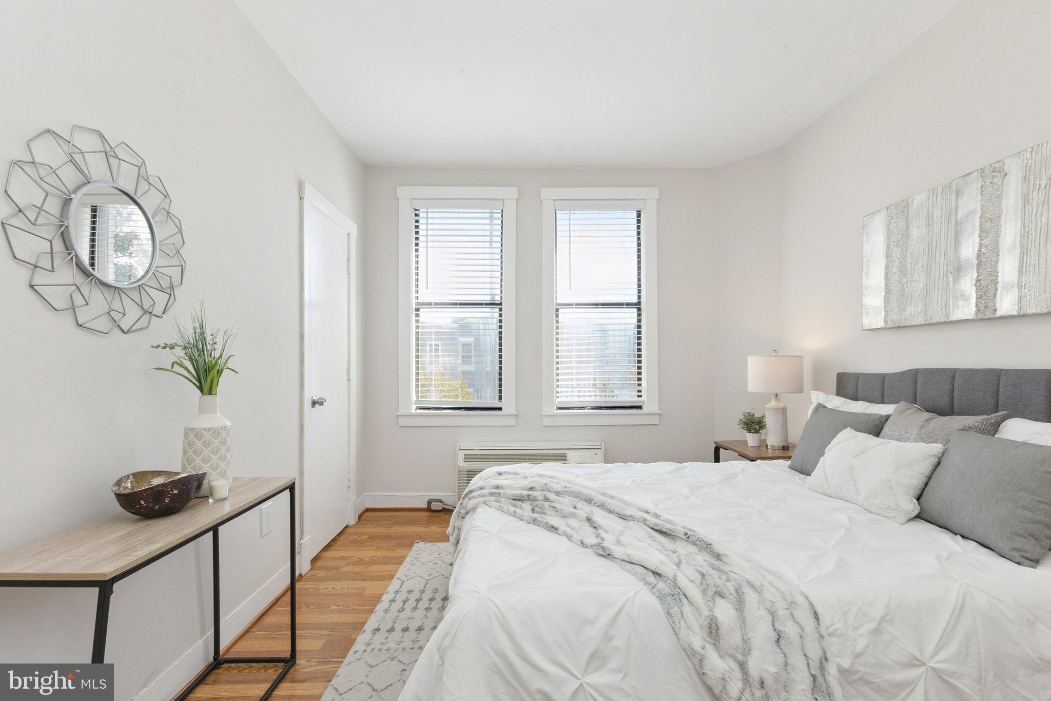 7 18th Street Southeast, Unit 208 Washington, DC 20003 - Photo 10 of 31 a bedroom with a bed a dresser and a window