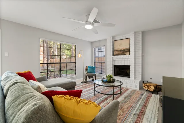 a bedroom with a bed and a ceiling fan