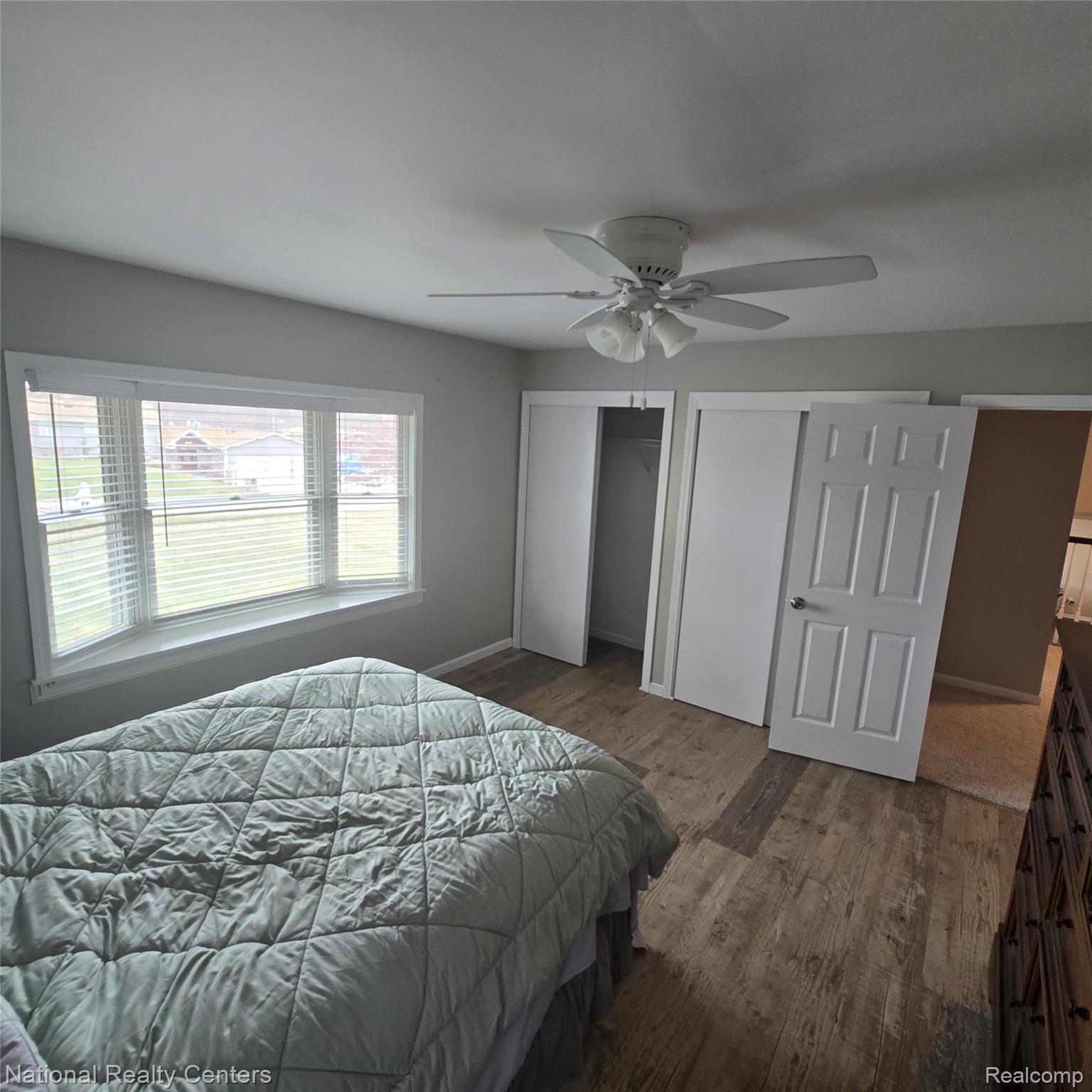 13477 South Horrell Road Fenton, MI 48430 - Photo 15 of 30 Bedroom with dark wood-style flooring, two closets, and ceiling fan