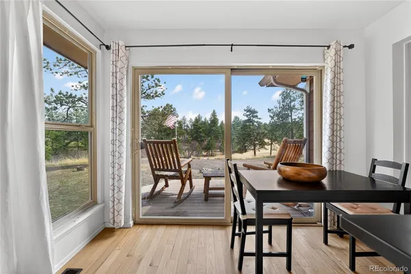 a dining room with a glass top table and chairs