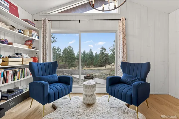 a living room with furniture a rug and a large window