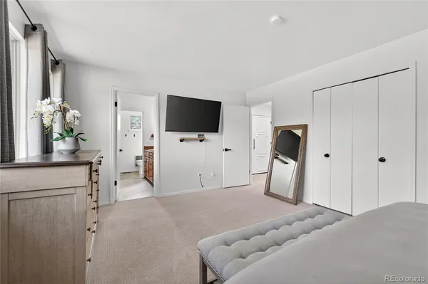 a view of a livingroom with furniture and a flat screen tv