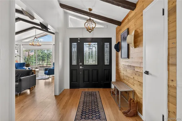 a hallway with a dining table and chairs