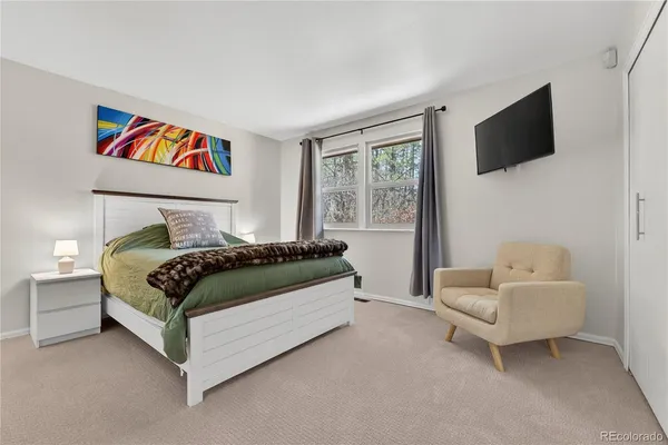 a bedroom with a bed and a flat screen tv