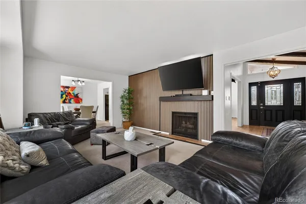 a living room with furniture a flat screen tv and a fireplace