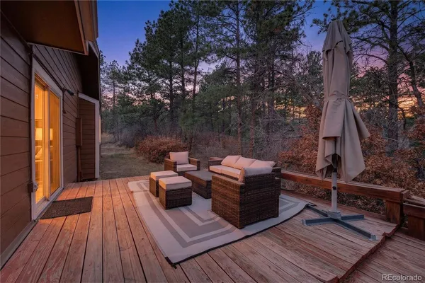 a view of roof deck with couches and wooden floor