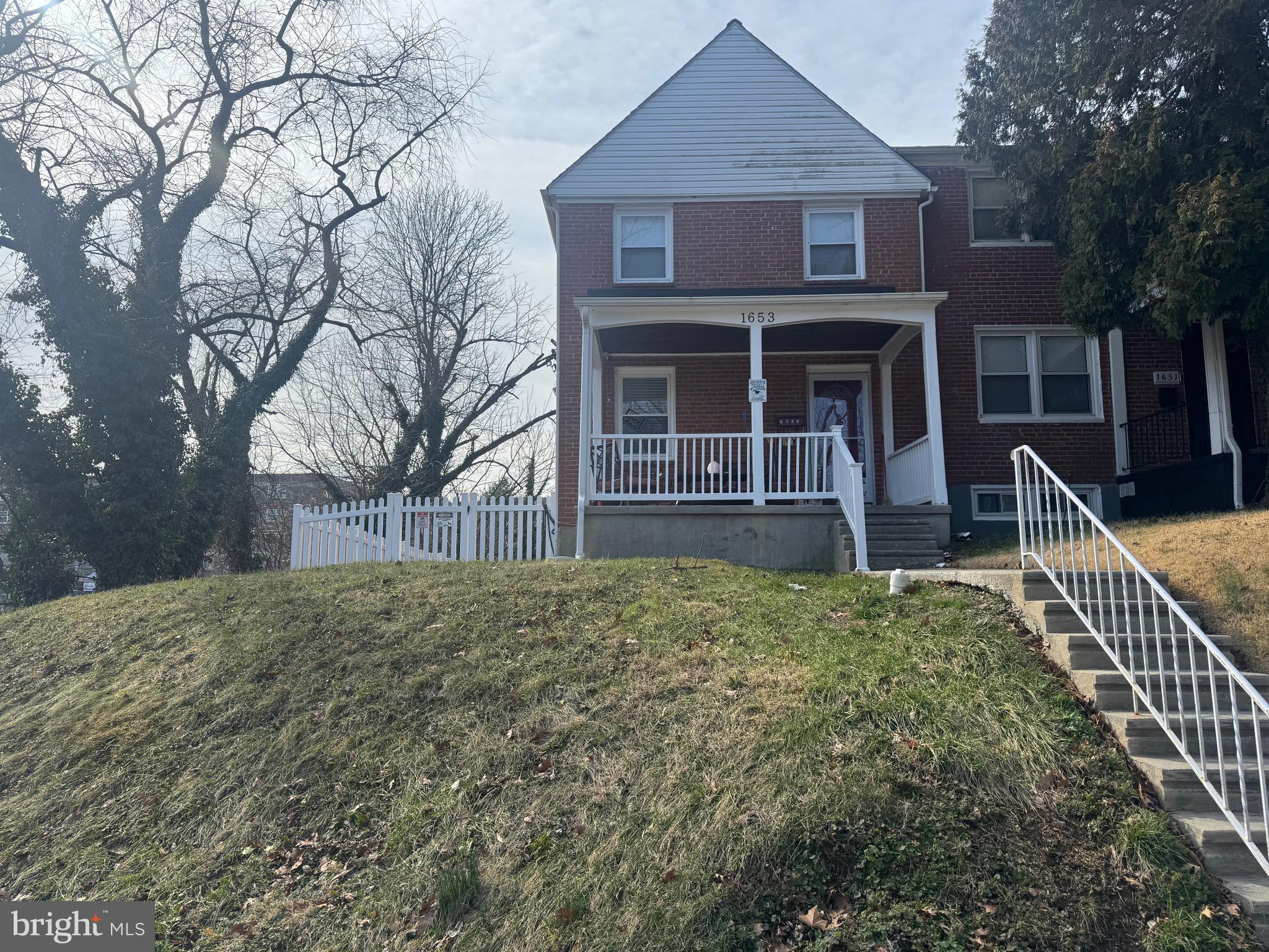 1653 Stonewood Road Baltimore, MD 21239 - Photo 1 of 17 a front view of a house with garden