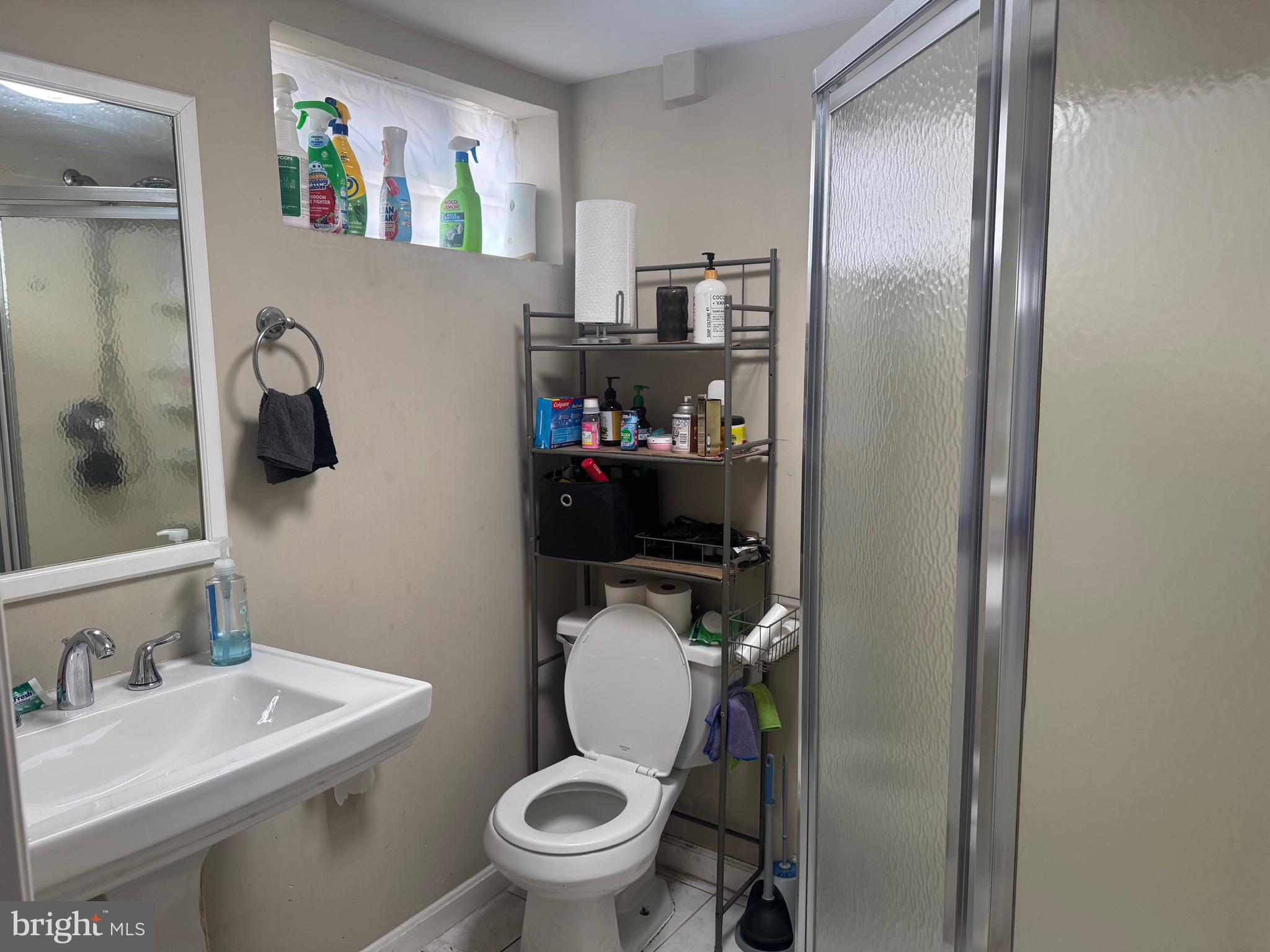 1653 Stonewood Road Baltimore, MD 21239 - Photo 16 of 17 a bathroom with a toilet a sink and shower