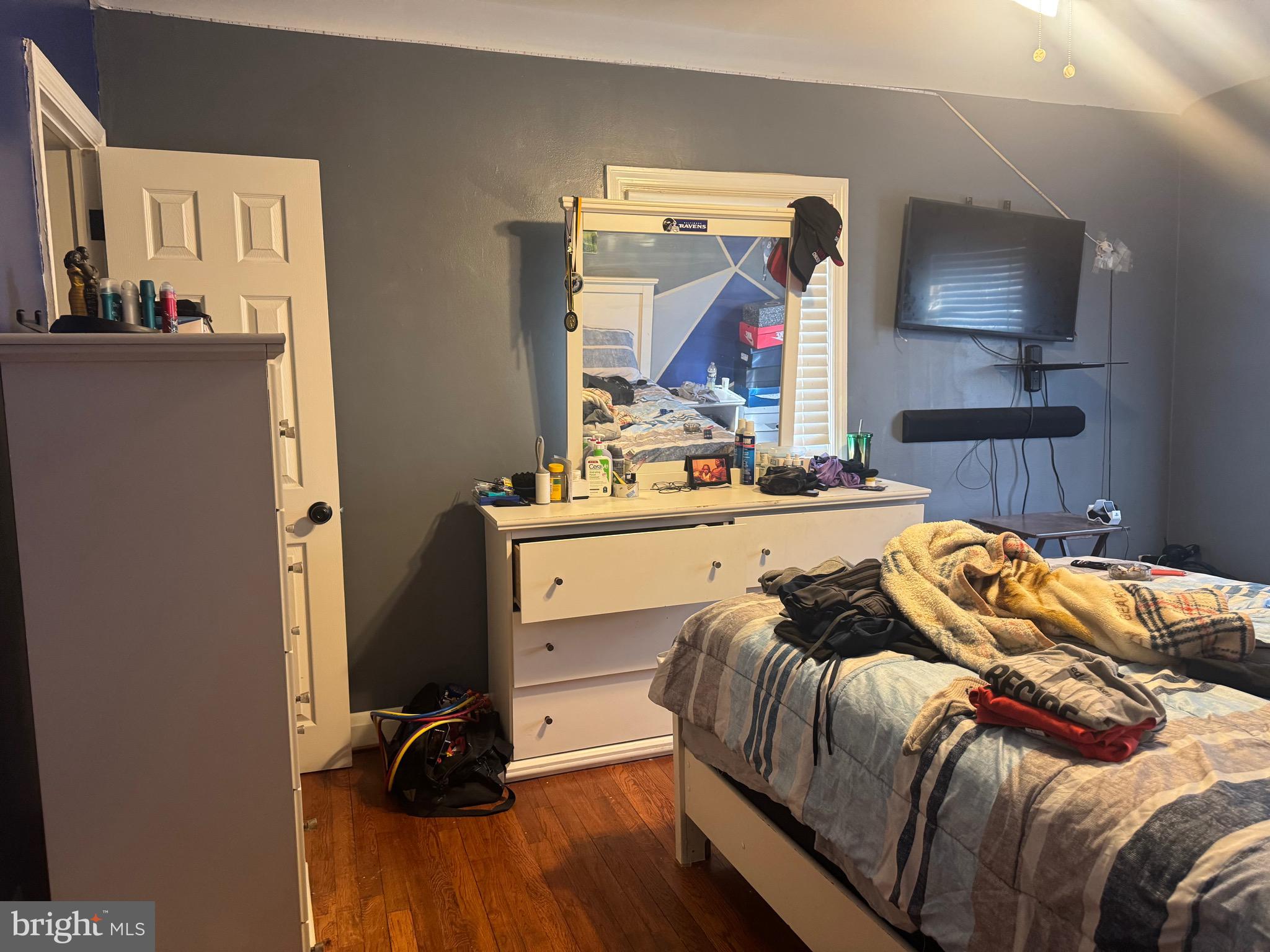 1653 Stonewood Road Baltimore, MD 21239 - Photo 10 of 17 a bedroom with a bed and a mirror