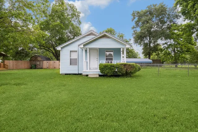a front view of house with yard and green space
