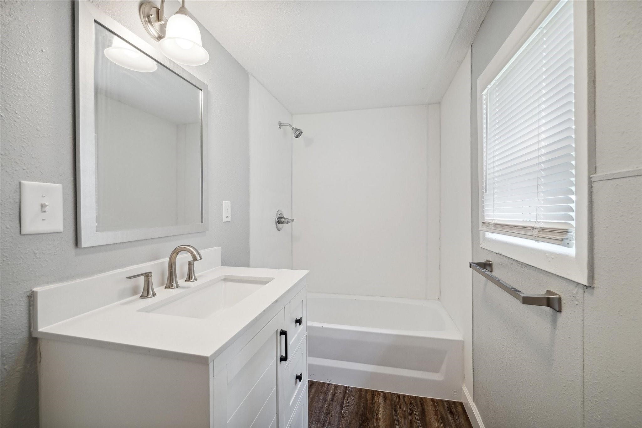 110 Maplewood Street Dayton, TX 77535 - Photo 11 of 12 a bathroom with a sink mirror vanity and a bathtub