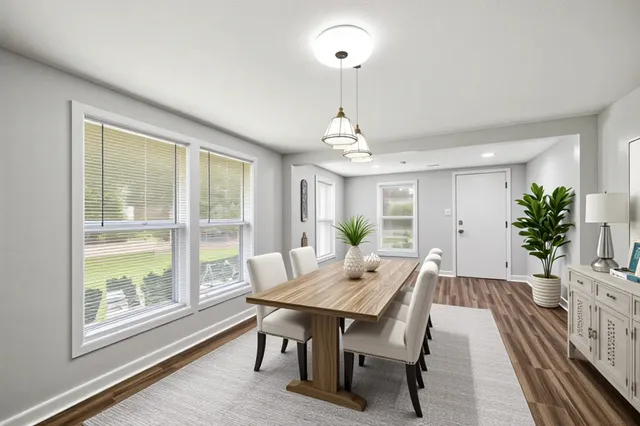 a view of a dining room with furniture window and wooden floor