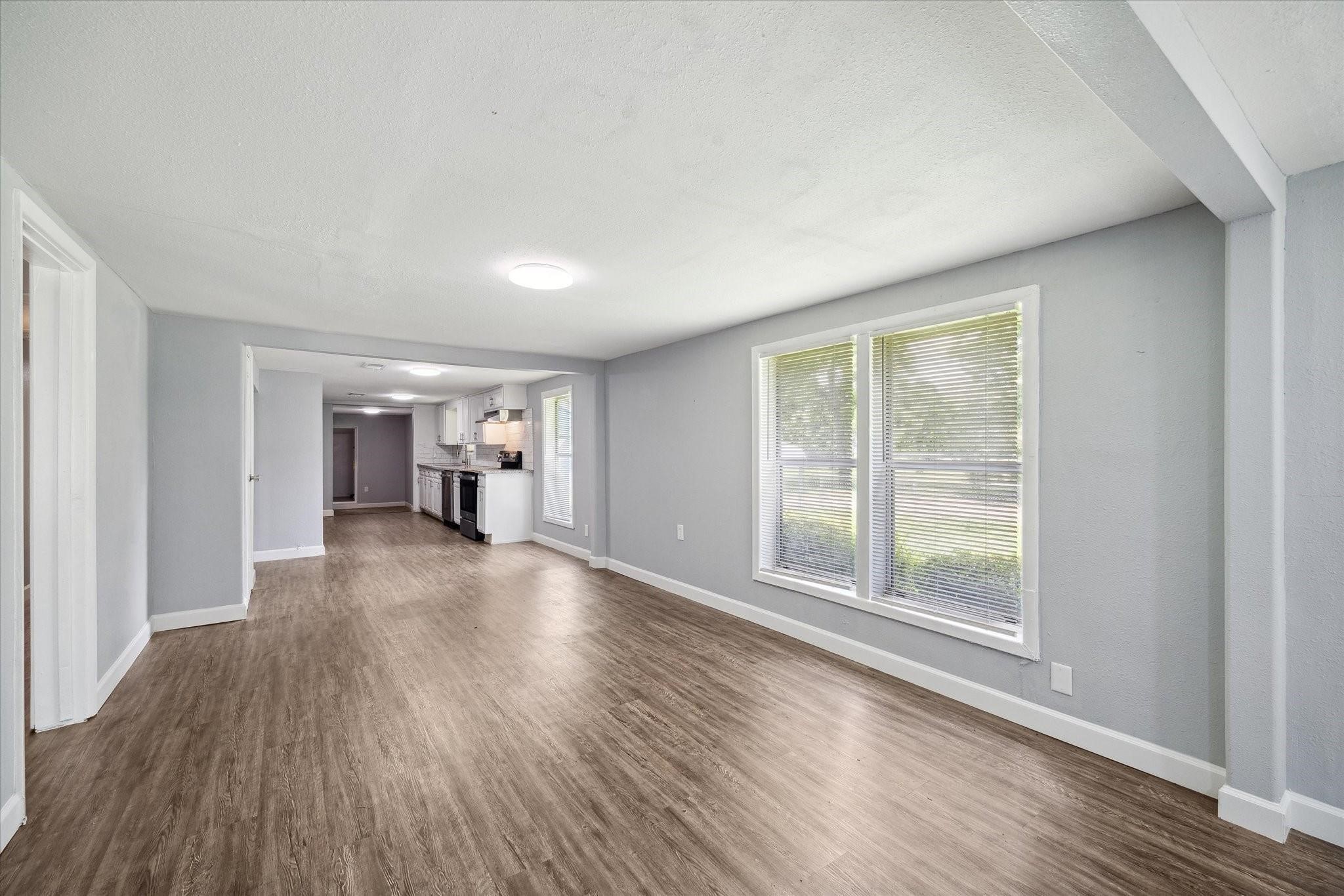 110 Maplewood Street Dayton, TX 77535 - Photo 5 of 12 a view of empty room with wooden floor and fan