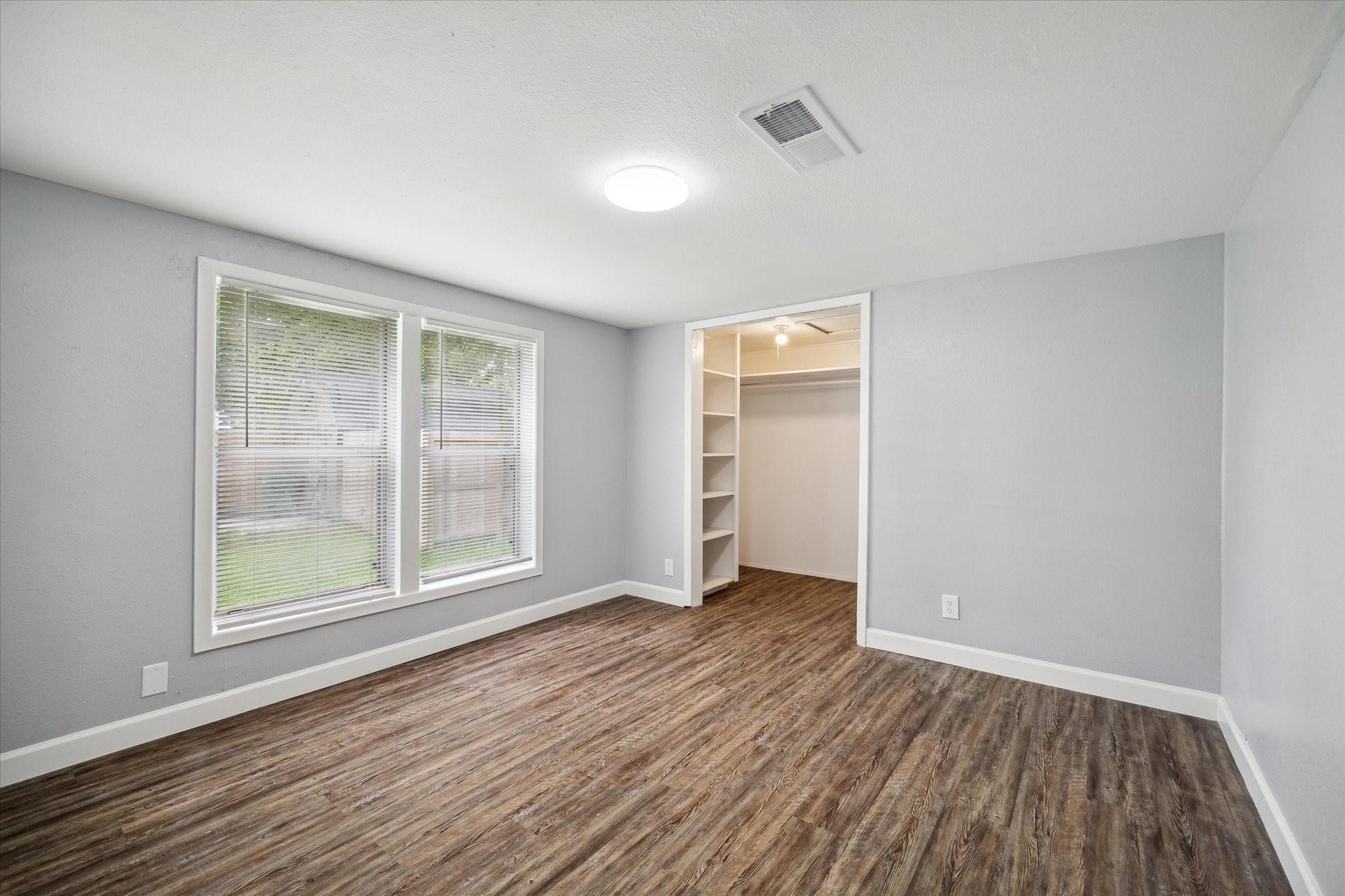 110 Maplewood Street Dayton, TX 77535 - Photo 7 of 12 an empty room with wooden floor and windows