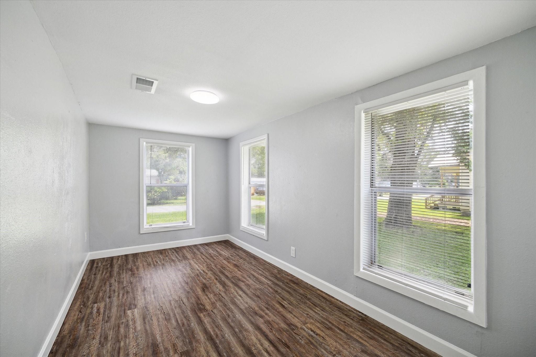110 Maplewood Street Dayton, TX 77535 - Photo 8 of 12 wooden floor in an empty room with a window