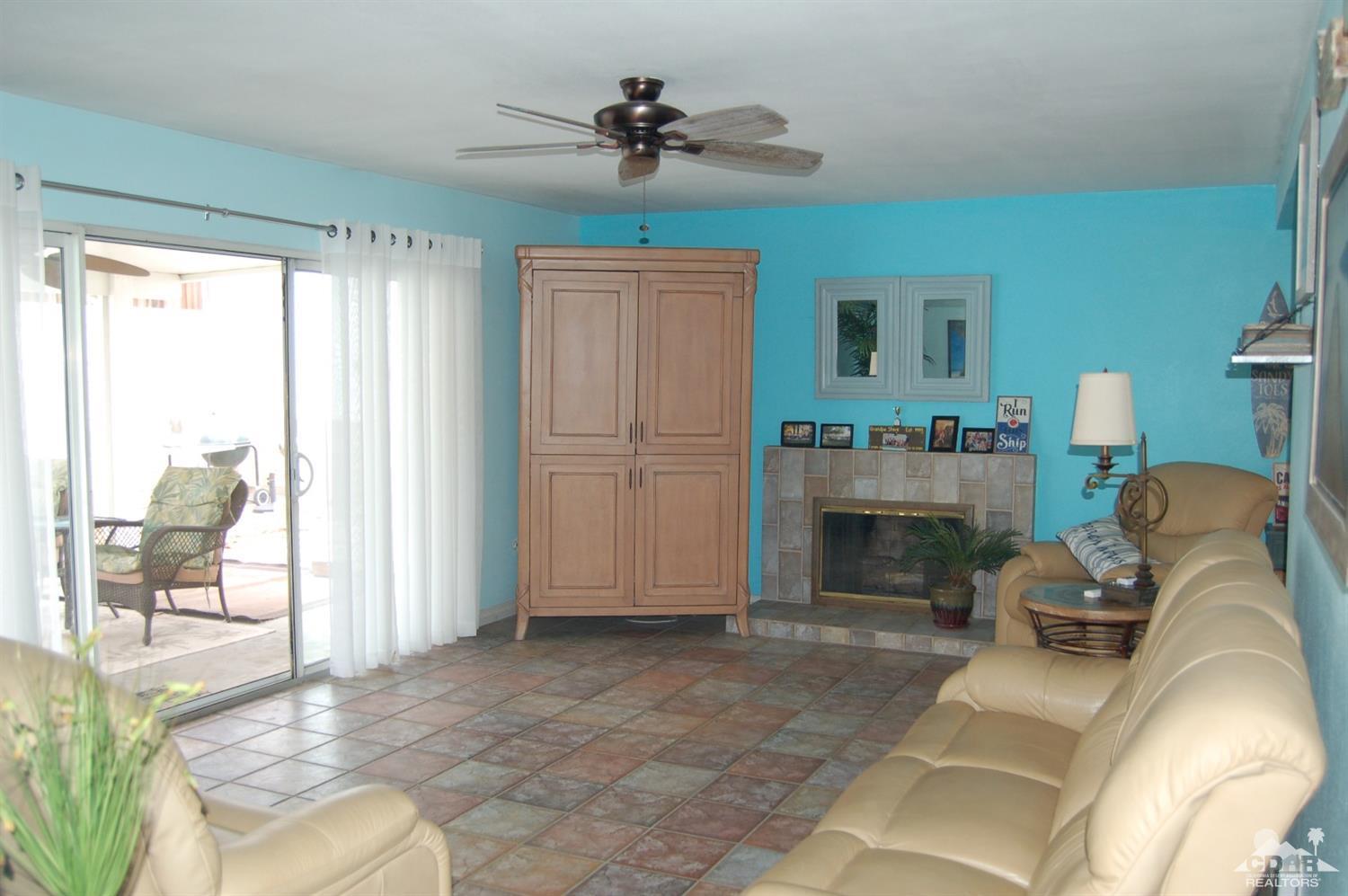 4591 Toyon Road Riverside, CA 92504 - Photo 14 of 40 a living room with furniture a fireplace and a table
