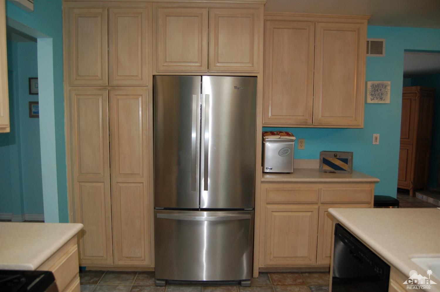 4591 Toyon Road Riverside, CA 92504 - Photo 21 of 40 a kitchen with a refrigerator and a stove top oven
