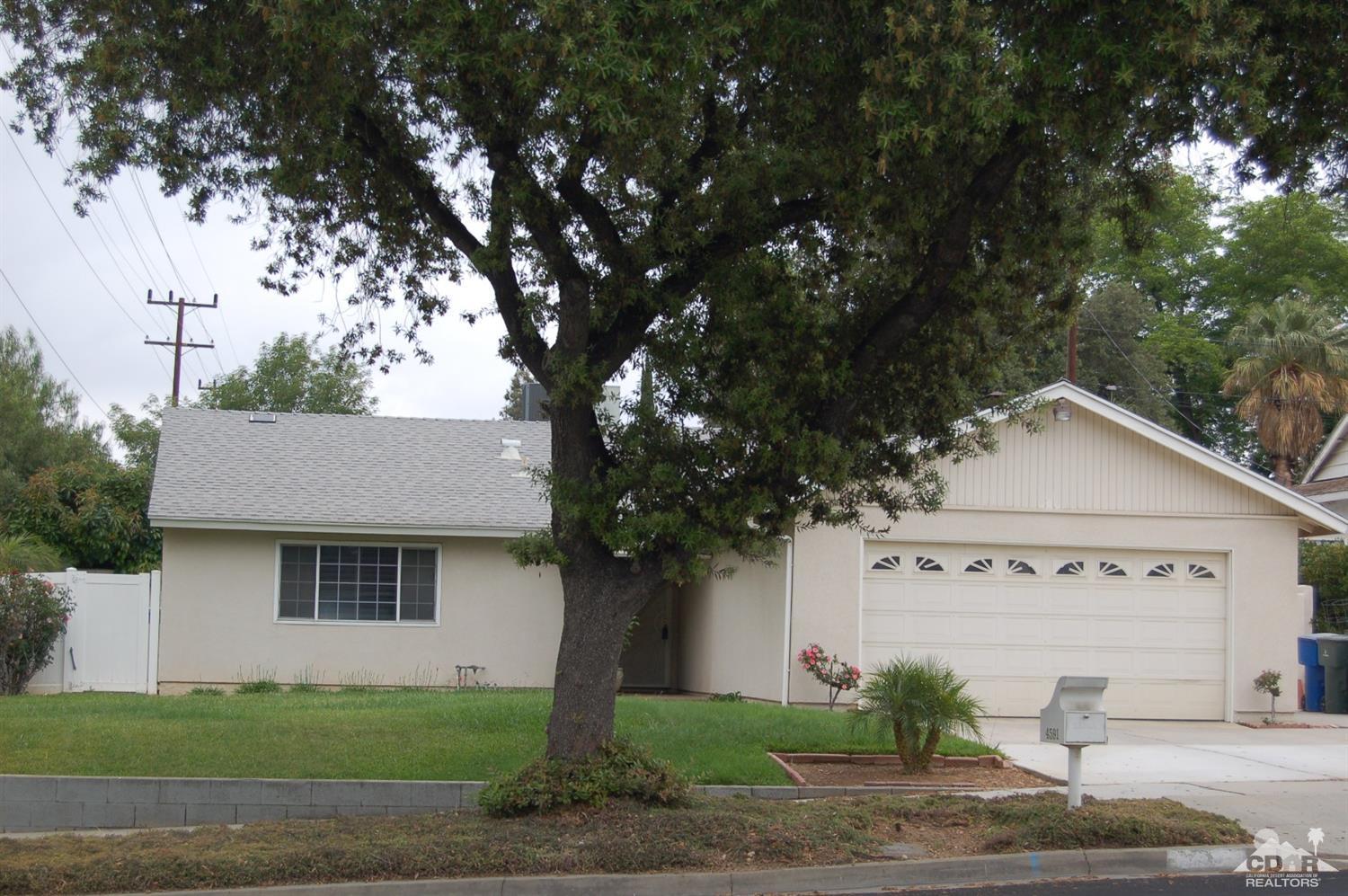 4591 Toyon Road Riverside, CA 92504 - Photo 25 of 40 a view of a white house with a tree and plants