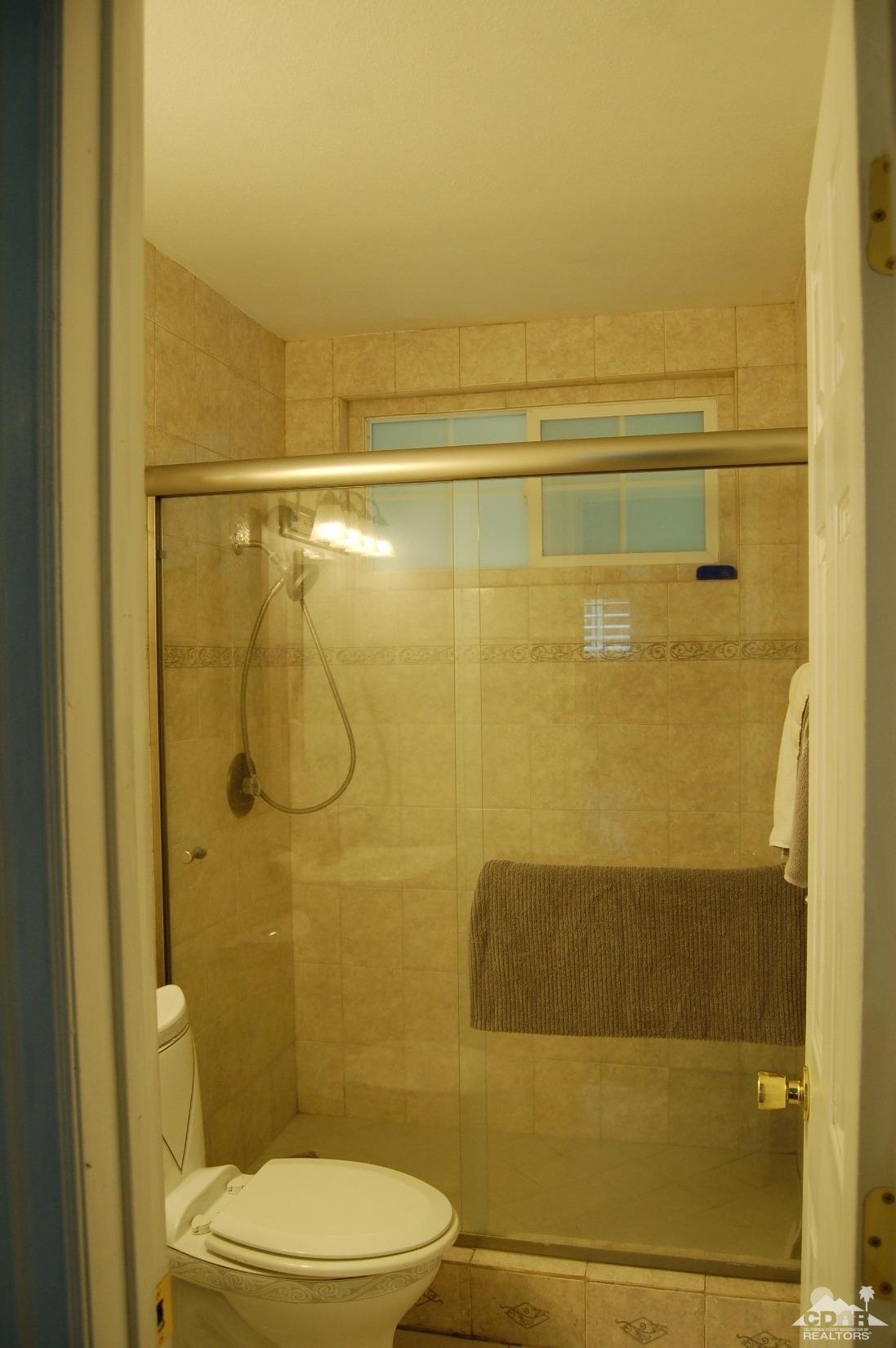 4591 Toyon Road Riverside, CA 92504 - Photo 34 of 40 a bathroom with a toilet and shower