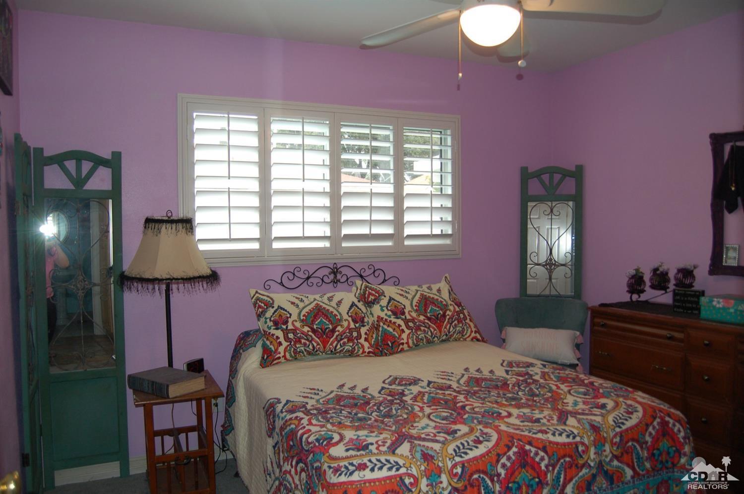 4591 Toyon Road Riverside, CA 92504 - Photo 38 of 40 a bedroom with a bed and a lamp on dresser