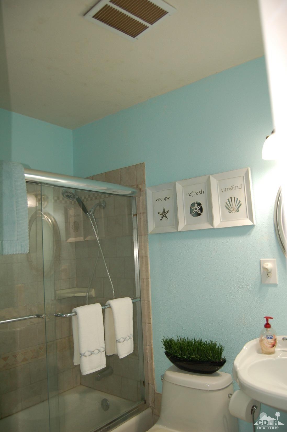 4591 Toyon Road Riverside, CA 92504 - Photo 40 of 40 a bathroom with a toilet and a shower curtain