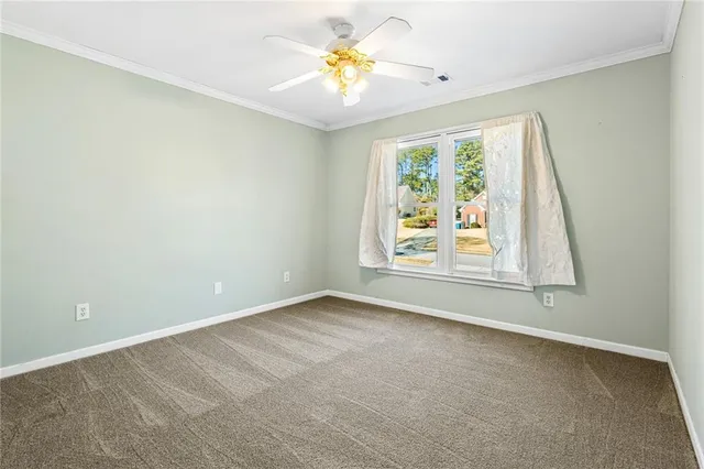 a view of room with window and ceiling fan