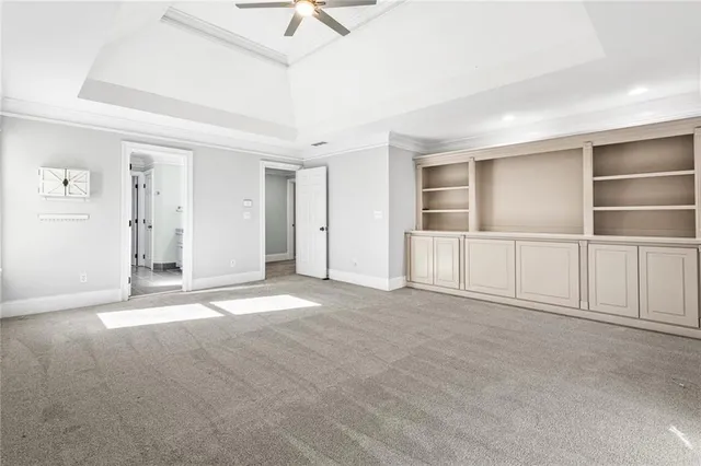 an empty room with a empty space and chandelier fan