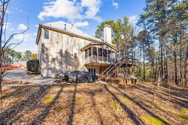 a view of a house with backyard and sitting area