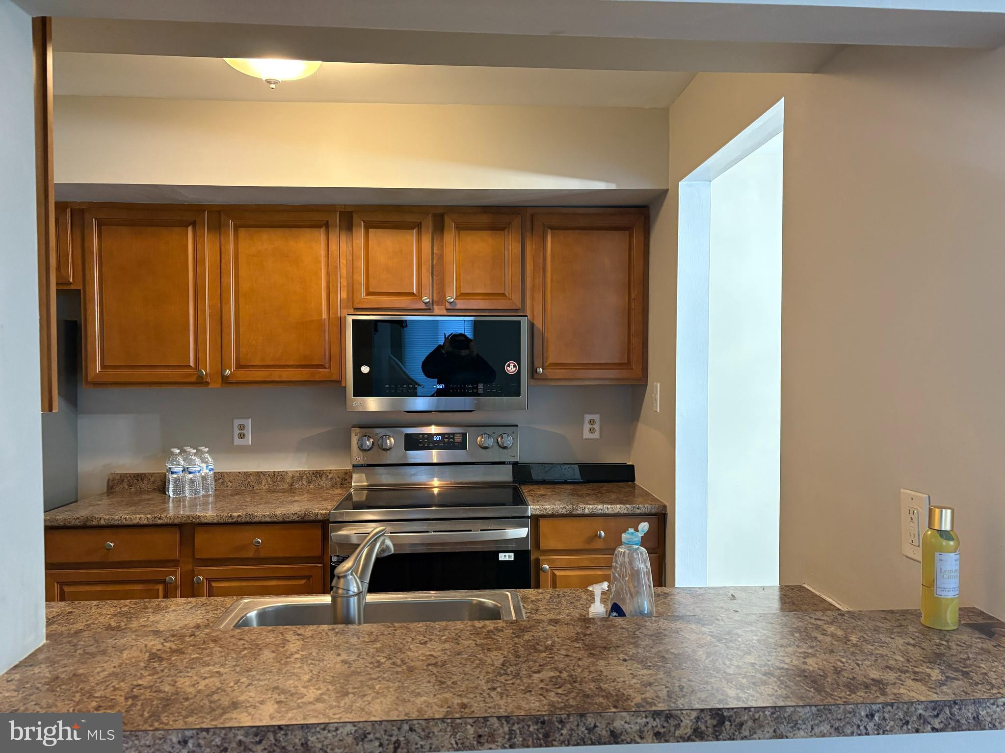 904 Gregorys Way Voorhees, NJ 08043 - Photo 15 of 19 a kitchen with wooden cabinets and a sink
