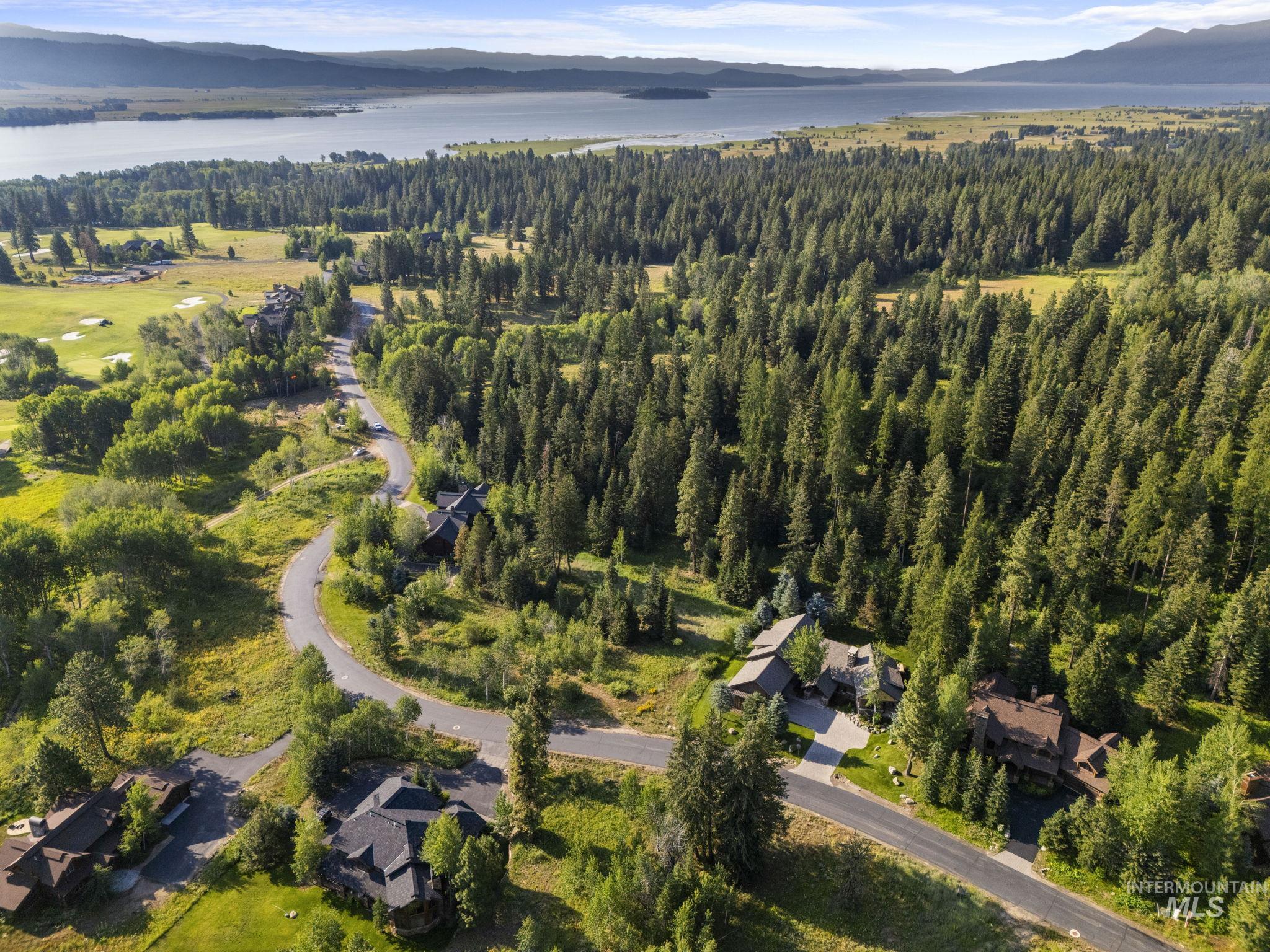 459 Discovery Drive Cascade, ID 83611 - Photo 13 of 17 Aerial view of property and surrounding area with a water and mountain view and a forest