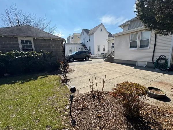 a view of a house with snow on the side of the road
