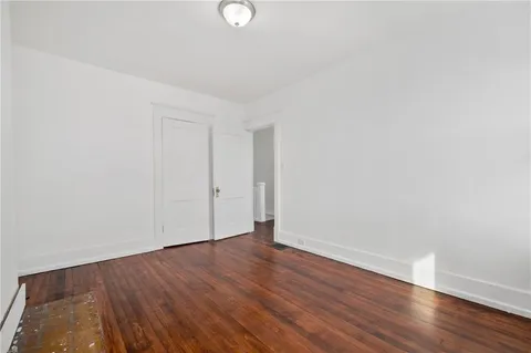 a view of a room with wooden floor